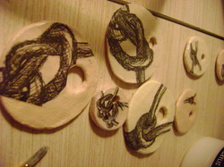 Knot ink drawings on ceramic pendants